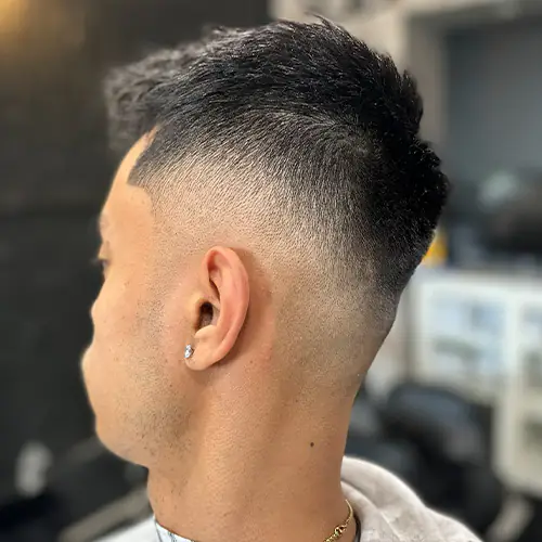 Finished low fade with a clean neckline and textured top