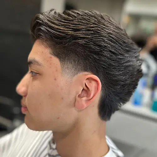 Finished longer haircut with sculpted texture and tapered sides