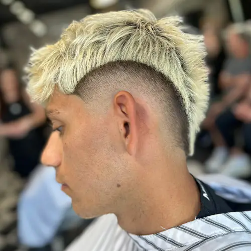 Finished high fade with a high-contrast blond textured top