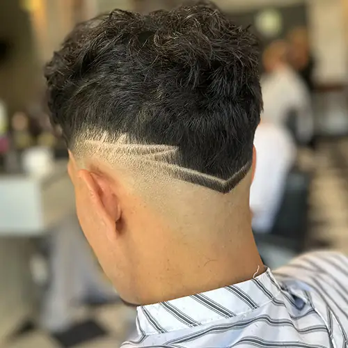 Finished fade with a precise double-line hair design