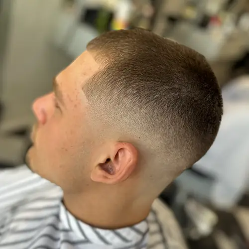 Finished close buzz cut with a smooth skin fade and sharp line-up