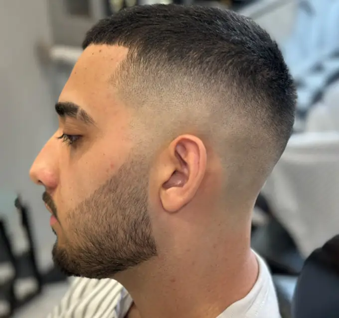Bald skin fade haircut at Dino's Barbershop